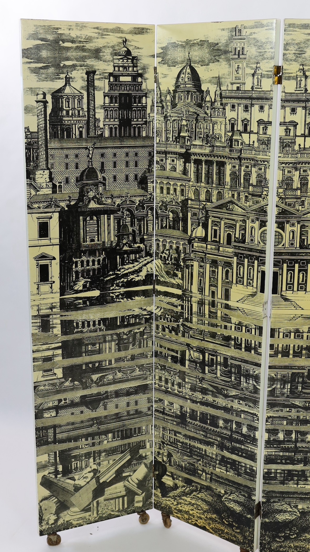 Piero Fornasetti (Italian, 1913-1988) - ‘’Citta Che Si Rispecchia’’ [City that reflects itself] four panel screen width of each section 50cm height without castors 200cm
